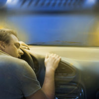 Guy alseep behind the wheel Guy alseep behind the wheel