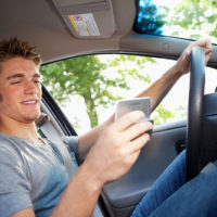 Teen boy distracted while driving Teen boy distracted while driving
