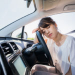 young female driver sleeping behind wheel as part of drowsy driving concept young female driver sleeping behind wheel as part of drowsy driving concept