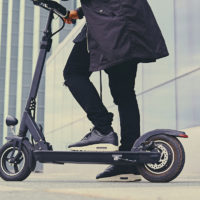 Close up image of a man on an electric scooter Close up image of a man on an electric scooter
