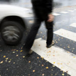Pedestrian walking on street almost gets hit by car Pedestrian walking on street almost gets hit by car