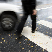Pedestrian accident about to happen with blurry focus on car and crossing man Pedestrian accident about to happen with blurry focus on car and crossing man