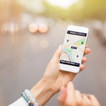 Woman using uber app on her phone Woman using uber app on her phone