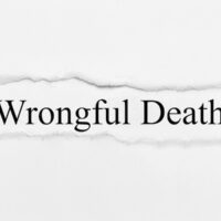 Wrongful Death on white torn paper