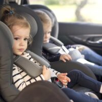 cute small twins in car seats in the car cute small twins in car seats in the car