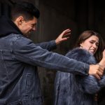 Criminal attacking young woman in alley. Self defense concept Criminal attacking young woman in alley. Self defense concept