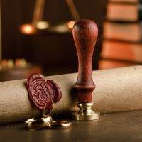 Notary public tools. Old stamp and document close-up.